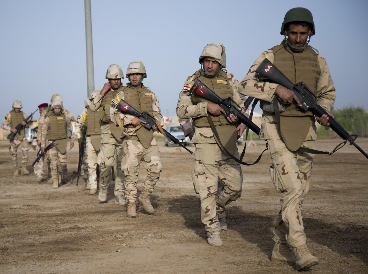 Iraqi security forces walk to a checkpoint training area at Camp Taji, Iraq.