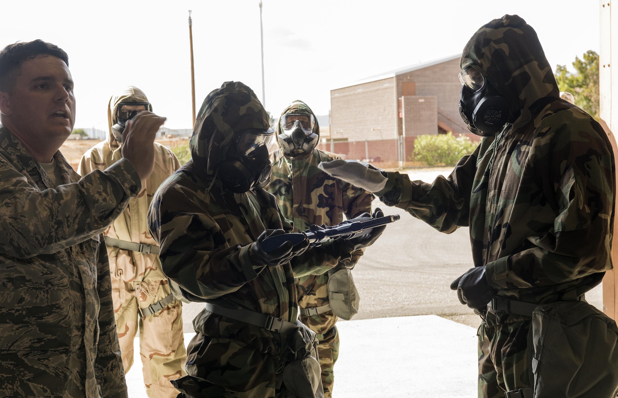 Tech Sgt. Donovan Root (left), 60th Civil Engineer Squadron, instructs Airmen on weapons decontamination during a chemical, biological, radiological and nuclear defense survival skills training course on Travis Air Force Base, Calif., Sep. 21, 2017. CBRN defenses are protective measures taken in situations in which chemical, biological, radiological or nuclear warfare (including terrorism) hazards may be present. CBRN defense consists of CBRN passive protection, contamination avoidance and CBRN mitigation. (U.S. Air Force photo by Heide Couch)