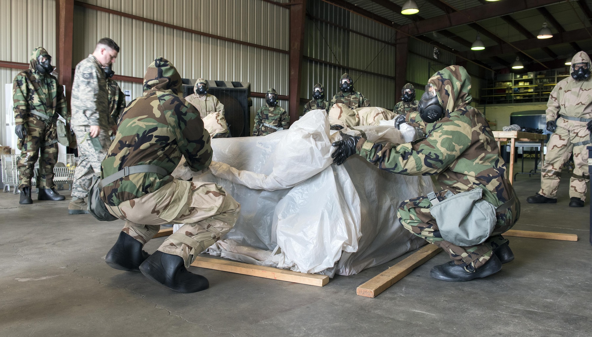 U. S. Air Force Airmen learn how to protect an “asset” during a chemical, biological, radiological and nuclear defense survival skills training course on Travis Air Force Base, Calif., Sep. 21, 2017. CBRN defenses are protective measures taken in situations in which chemical, biological, radiological or nuclear warfare (including terrorism) hazards may be present. CBRN defense consists of CBRN passive protection, contamination avoidance and CBRN mitigation. (U.S. Air Force photo by Heide Couch)