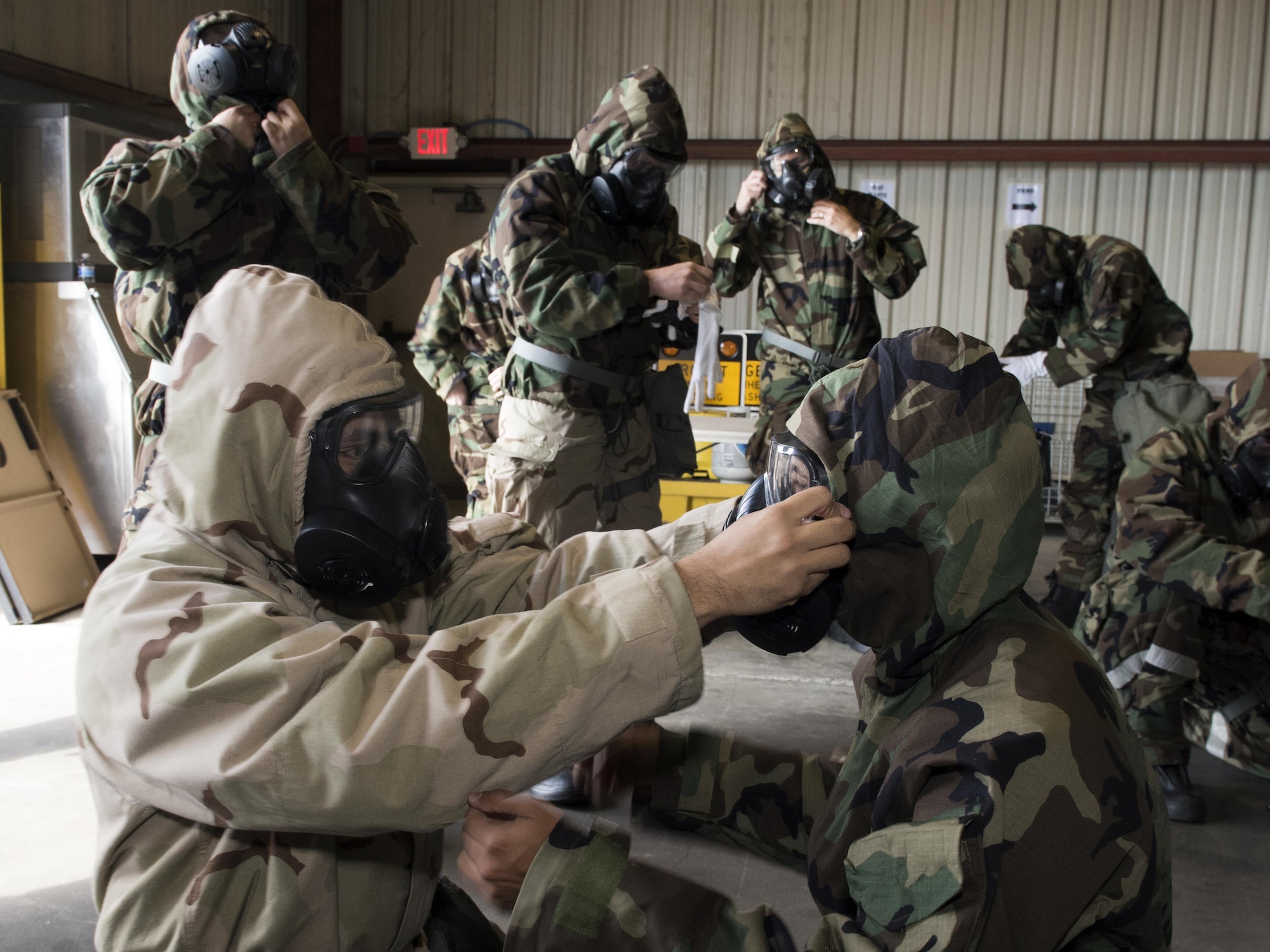 U. S. Air Force Airmen check each other’s protective equipment to ensure a proper seal during a chemical, biological, radiological and nuclear defense survival skills training course at Travis Air Force Base, Calif., Sep. 21, 2017. Buddy checks are designed to ensure Airmen have properly assembled their mission-oriented protective posture gear. (U.S. Air Force photo by Heide Couch)