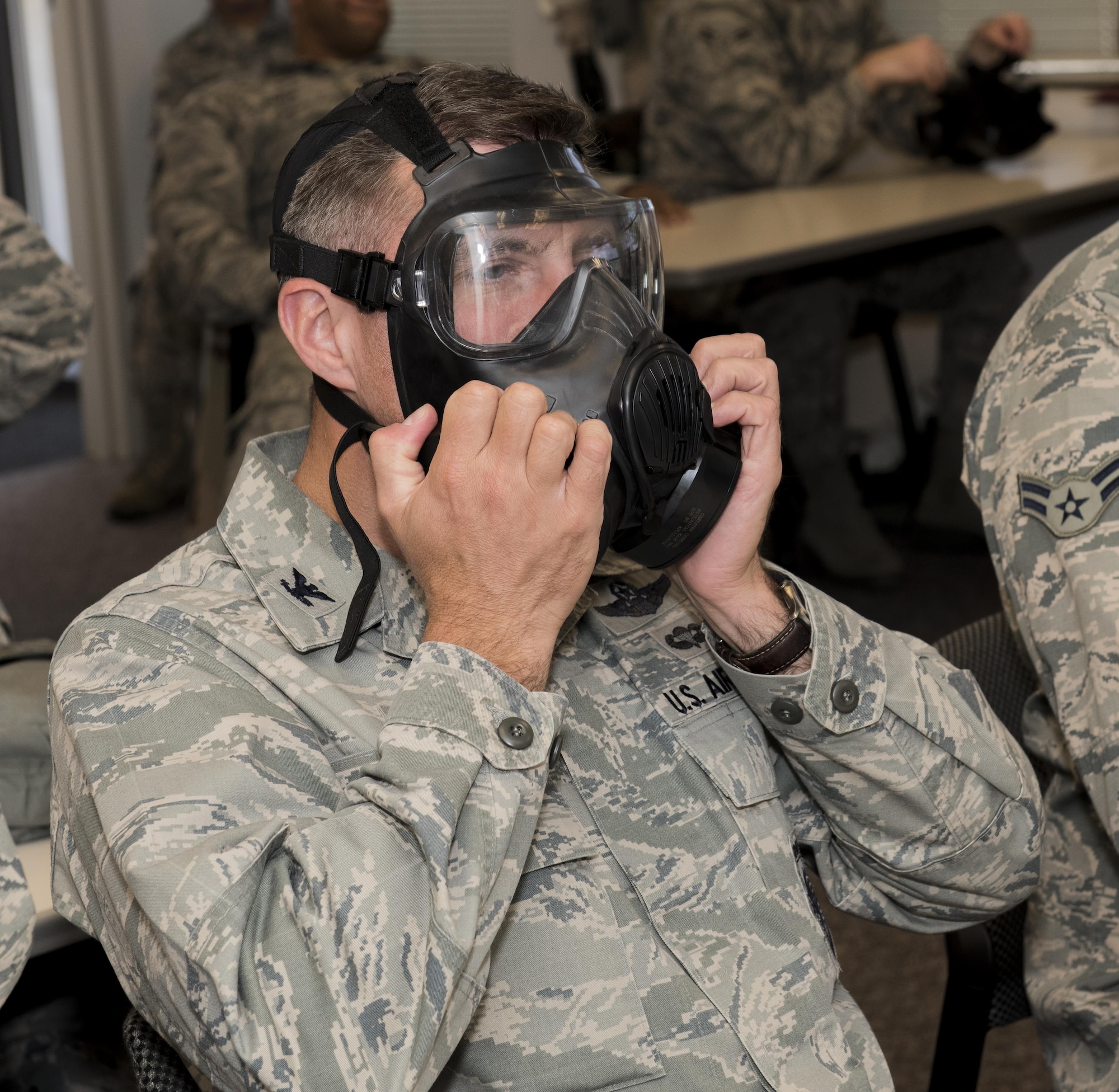 U.S. Air Force Col. John Klein, the commanding officer of the 60th Air Mobility Wing, checks the respirators on his gas mask during a chemical, biological, radiological and nuclear defense survival skills training course on Travis Air Force Base, Calif., Sep. 21, 2017. CBRN defenses are protective measures taken in situations in which chemical, biological, radiological or nuclear warfare (including terrorism) hazards may be present. CBRN defense consists of CBRN passive protection, contamination avoidance and CBRN mitigation. (U.S. Air Force photo by Heide Couch)
