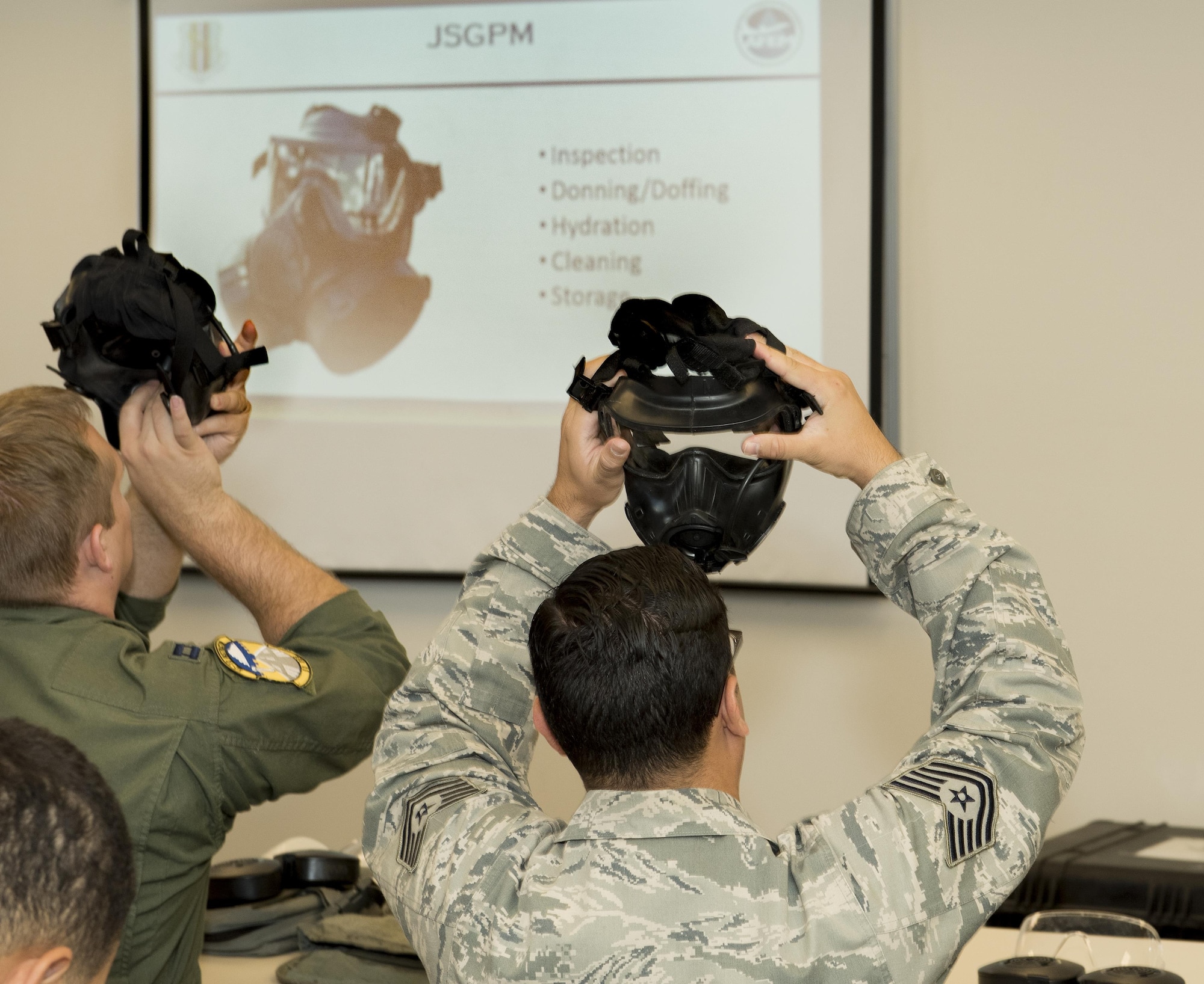 U.S. Air Force Airmen inspect their gas masks during a chemical, biological, radiological and nuclear defense survival skills training course on Travis Air Force Base, Calif., Sep. 21, 2017. CBRN defenses are protective measures taken in situations in which chemical, biological, radiological or nuclear warfare (including terrorism) hazards may be present. CBRN defense consists of CBRN passive protection, contamination avoidance and CBRN mitigation. (U.S. Air Force photo by Heide Couch)