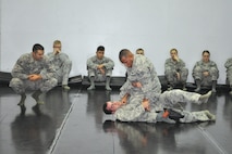 Members of the 72nd Security Forces Squadron apply different techniques during live rolls, an exercise used in combatives training. Staff Sgt. Patrick Johnson, an instructor with Security Forces, observes as defenders execute live rolls at the end of their training course. The combatives training course is dedicated to enhancing self-defense skills for close-quarter, hand-to-hand combat.