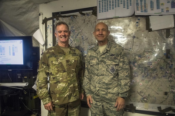 U.S. Air Force Gen. Mike Holmes, commander of Air Combat Command, right, poses for a photo with U.S. Army Maj. Gen. Walter E. Piatt, 10th Mountain Division commander, during his visit to the 20th Air Support Operations Squadron and 10th Mountain Division, Oct. 9, 2017, at Fort Drum, N.Y. Holmes visited Airmen belonging to the 14th, 20th and 682d ASOS, and 18th Weather Squadron Detachment 1 during Warfighters Exercise 18-1, to observe Airmen fully engaged in roles they would fill for the Army while downrange. (U.S. Air Force photo by Senior Airman Janiqua P. Robinson)