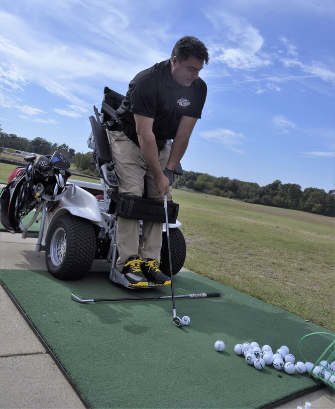 Anthony Netto, Stand Up and Play Foundation founder, takes aim before striking a golf ball at Joint Base Andrews, Md., Oct. 6, 2017. The demonstration was part of National Disability Employment Awareness Month, a time set aside in the U.S. to affirm and recognize the many contributions of American workers with disabilities.