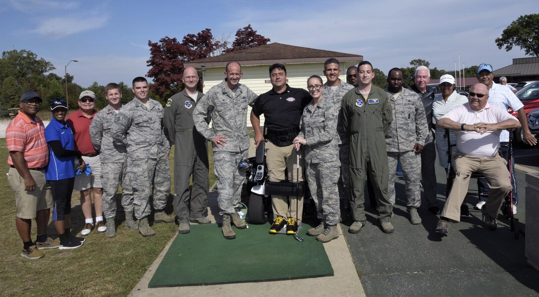 Anthony Netto, center, Stand Up and Play Foundation founder, poses for a photo with golf demonstration participants at Joint Base Andrews, Md., Oct. 6, 2017. The demonstration was part of National Disability Employment Awareness Month, a time set aside in the U.S. to affirm and recognize the many contributions of American workers with disabilities.