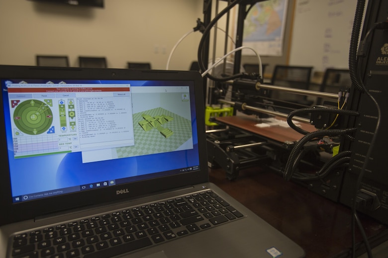 The 3-D printer from 2nd Battalion, 8th Marine Regiment is connected to a laptop with software and layouts needed to make pack clips at Camp Lejeune, N.C., Oct. 6, 2017. 2/8 is the first infantry battalion in the United States Marine Corps to utilize a 3-D printer to ensure battalion readiness in the event of equipment malfunctions. (U.S. Marine Corps photo by Lance Cpl. Ashley McLaughlin)