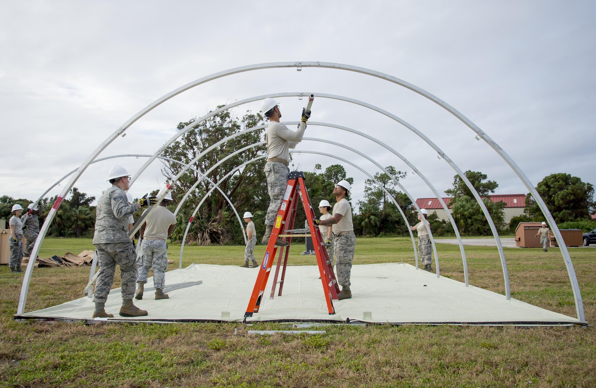 U.S. Air Force Airmen assigned to the 6th Force Support Squadron, setup the supporting structure of a Small Shelter System during Home Station Training at MacDill Air Force Base, Fla., Oct. 5, 2017. During the two-day course, Airmen receive approximately eight hours of classroom instruction and around seven hours of hands-on training. (U.S. Air Force photo by Senior Airman Mariette Adams)