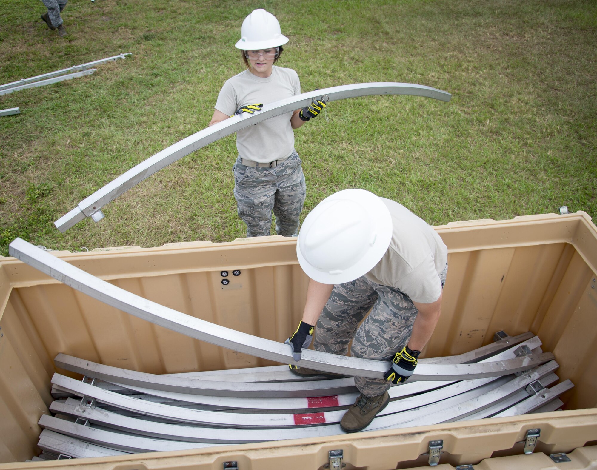 Services Airmen assigned to the 6th Force Support Squadron, place supporting beams from a Small Shelter System in to a pallet container during Home Station Training at MacDill Air Force Base, Fla., Oct. 5, 2017. During the two-day course, Airmen receive approximately eight hours of classroom instruction and around seven hours of hands-on training. (U.S. Air Force photo by Senior Airman Mariette Adams)