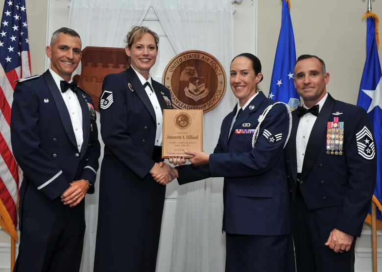 U.S. Air Force Senior Airman Jeannette Hilliard, 28th Operational Weather Squadron, receives the Commandant Award from Master Sgt. Lindsey Wolf, Senior Master Sgt. David B. Reid Airman Leadership School (ALS) commandant, during the ALS class 17-7 graduation ceremony at Shaw Air Force Base, S.C., Oct. 6, 2017.