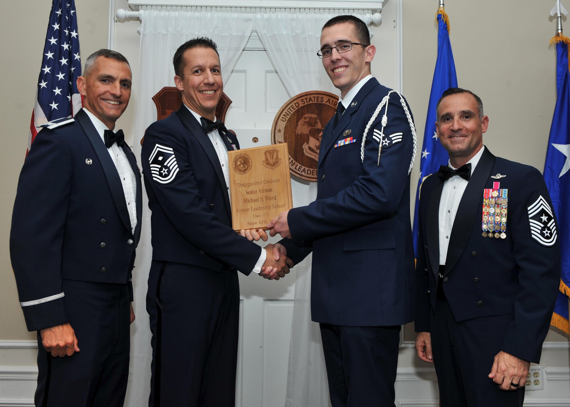U.S. Air Force Senior Airman Michael Ward, 31st Intelligence Squadron, receives a Distinguished Graduate Award from Senior Master Sgt. Keith Rivers of the Shaw Diamond Council, during the Senior Master Sgt. David B. Reid Airman Leadership School Class 17-7 graduation ceremony at Shaw Air Force Base, S.C., Oct. 6, 2017.