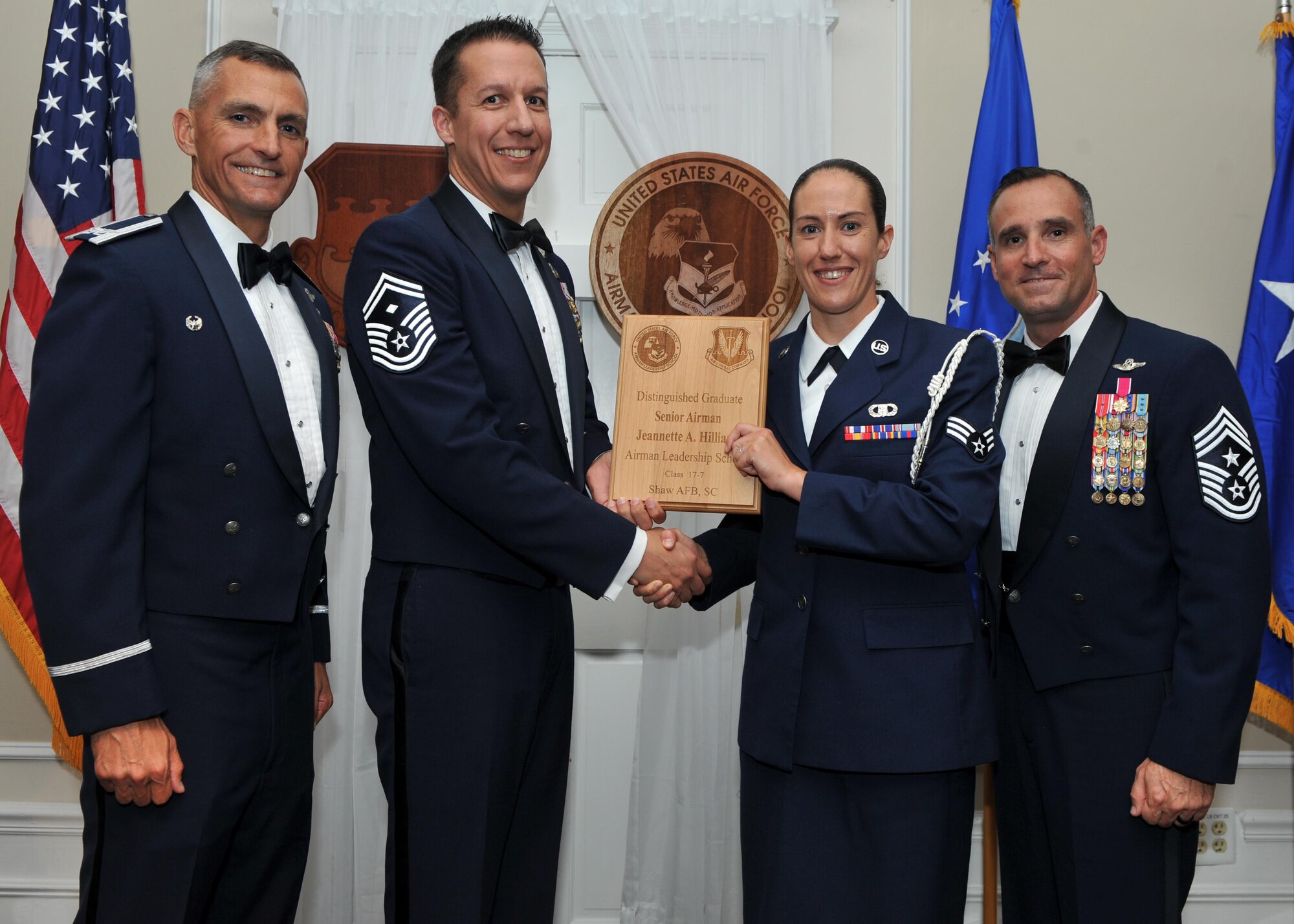 U.S. Air Force Senior Airman Jeannette Hilliard, 28th Operational Weather Squadron, receives a Distinguished Graduate Award from Senior Master Sgt. Keith Rivers of the Shaw Diamond Council, during the Senior Master Sgt. David B. Reid Airman Leadership School Class 17-7 graduation ceremony at Shaw Air Force Base, S.C., Oct. 6, 2017.