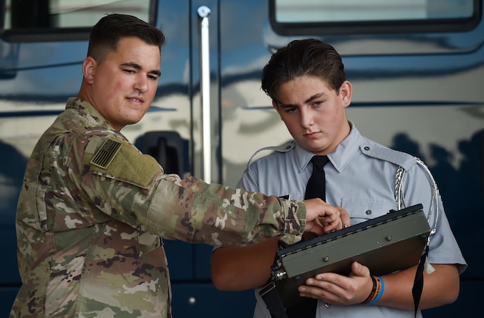 Senior Airman Matthew Reames, left, 628th Civil Engineer Squadron explosive ordnance disposal technician, shows Robert Snelson, St. Johns High School Army Junior Reserve Officer Training Corps member, how to operate an F6 robot during Joint Base Charleston’s annual Career Day here Oct. 11, in South Carolina. Junior ROTC units attended Career Day to get a closer look at what it's like to serve in the U.S. Military. Career Day is a way for the base to connect with young, and possible future service members in the community. Approximately 250 Junior ROTC cadets had the opportunity to have a face-to-face interaction with service members representing the U.S. Army, U.S. Marine Corps, U.S. Navy, U.S. Air Force and U.S. Coast Guard.
