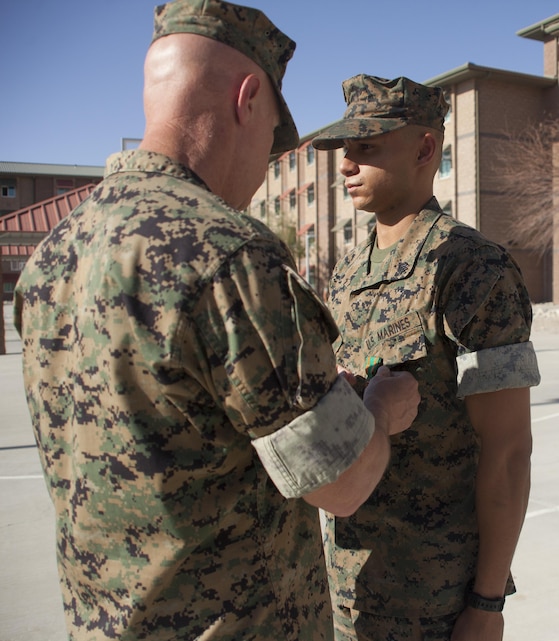 Sgt. Rajyon Imes, barracks manager, 7th Marine Regiment, was awarded a Navy and Marine Corps Achievement Medal by Col. William H. Vivian, commanding officer, 7th Marine Regiment, Oct. 5, 2017, for his contribution to the renovations at barracks 1404 aboard the Combat Center. Marines with 7th Marines and Public Works Division personnel renovated rooms and lounges for the purpose of providing improved living quarters for the deployed Marines of the regiment. (U.S. Marine Corps photo by Cpl. Natalia Cuevas)