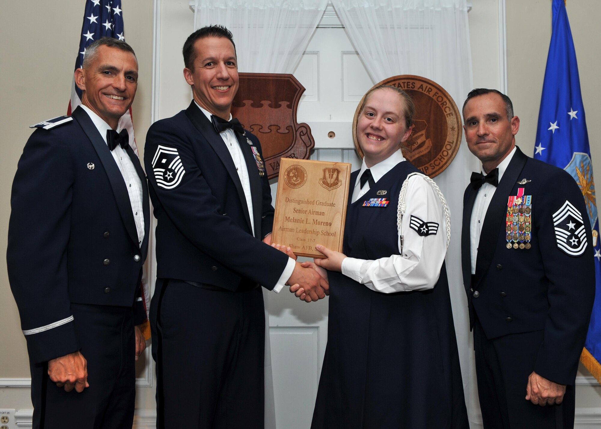 U.S. Air Force Senior Airman Melanie Moreno, 20th Component Maintenance Squadron, receives a Distinguished Graduate Award from Senior Master Sgt. Keith Rivers of the Shaw Diamond Council, during the Senior Master Sgt. David B. Reid Airman Leadership School Class 17-7 graduation ceremony at Shaw Air Force Base, S.C., Oct. 6, 2017.