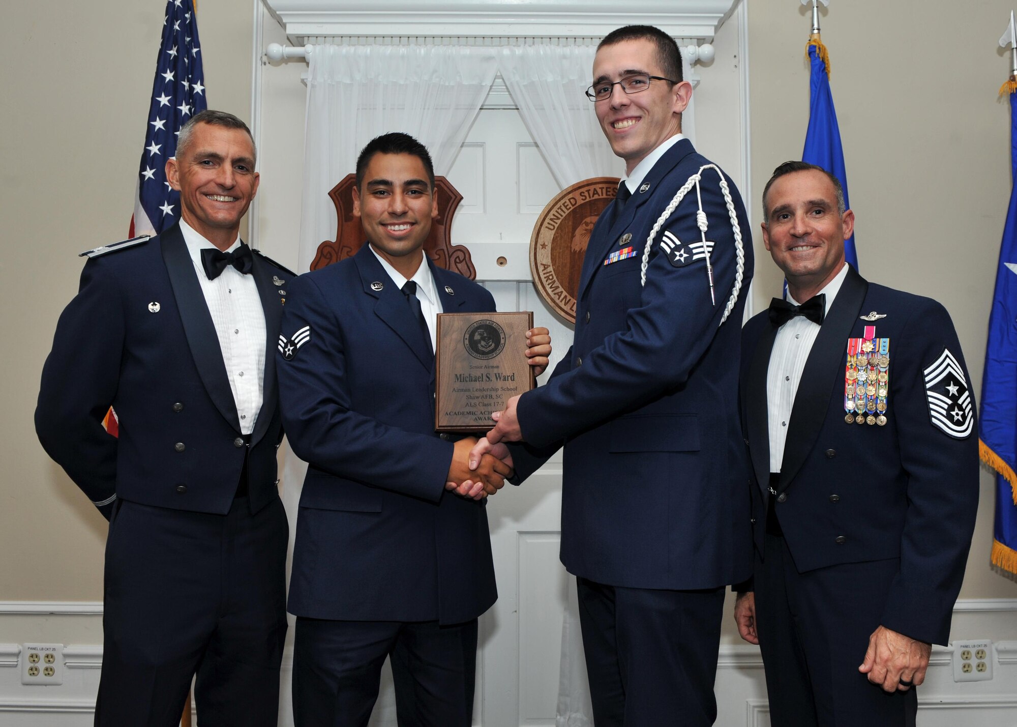 U.S. Air Force Senior Airman Michael Ward, 31st Intelligence Squadron, receives the Academic Achievement Award from Senior Airman Adrian Roybal of the Air Force Sergeants Association, during the Senior Master Sgt. David B. Reid Airman Leadership School class 17-7 graduation ceremony at Shaw Air Force Base, S.C., Oct. 6, 2017.