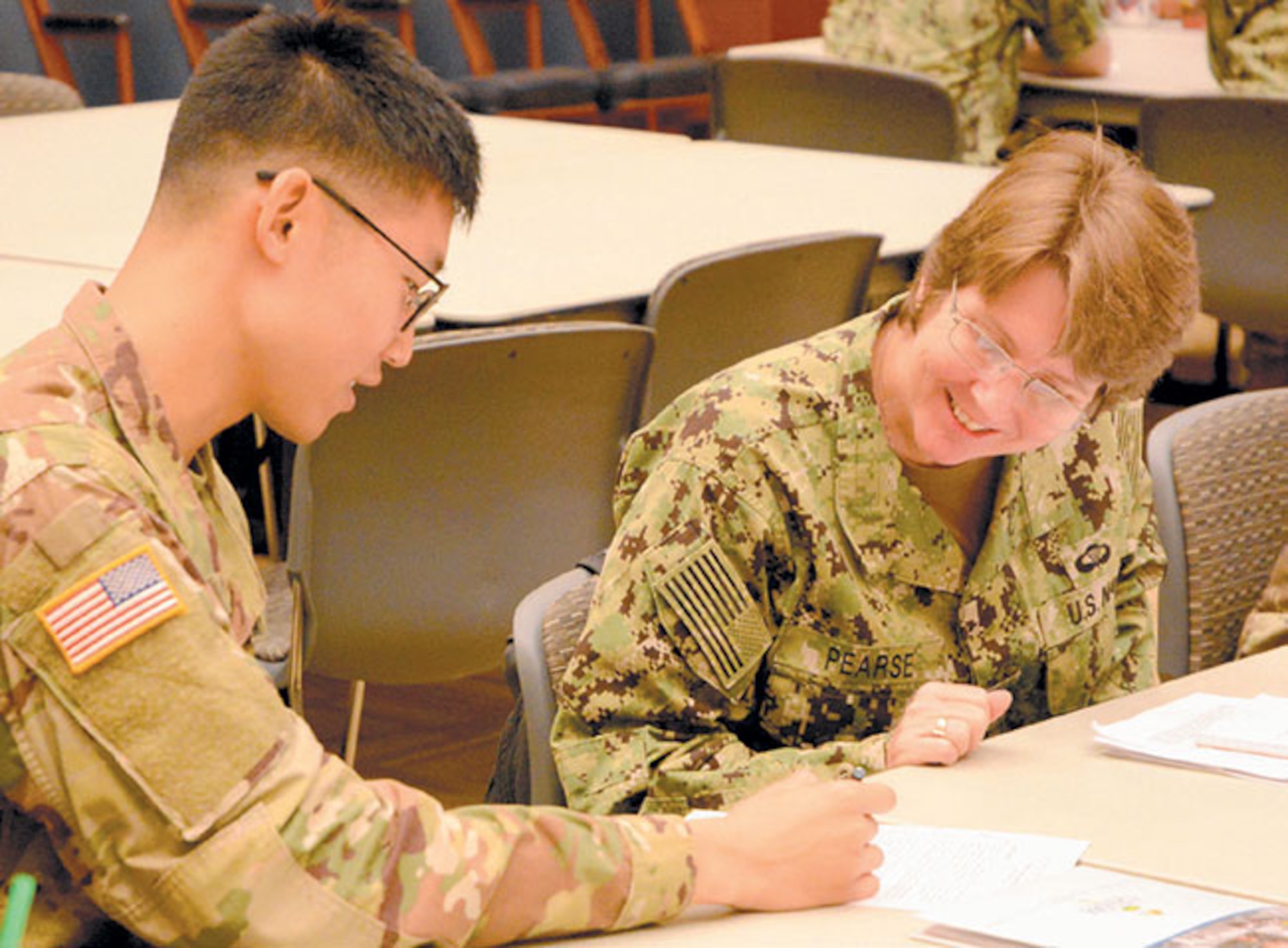 Capt. Lisa Pearse, M.D., director of Global Health Engagement, Navy Environmental and Preventative Medicine Unit Six, discusses details of a disaster response planning culmination exercise with U.S. Army Soldier.