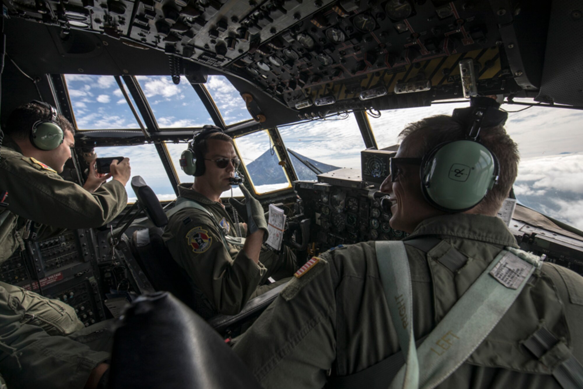 Crew members with the 36th Airlift Squadron communicate during a training mission near Mount. Fuji, Japan, Oct. 5, 2017. This is the last active duty C-130H Hercules tactical training sortie.
