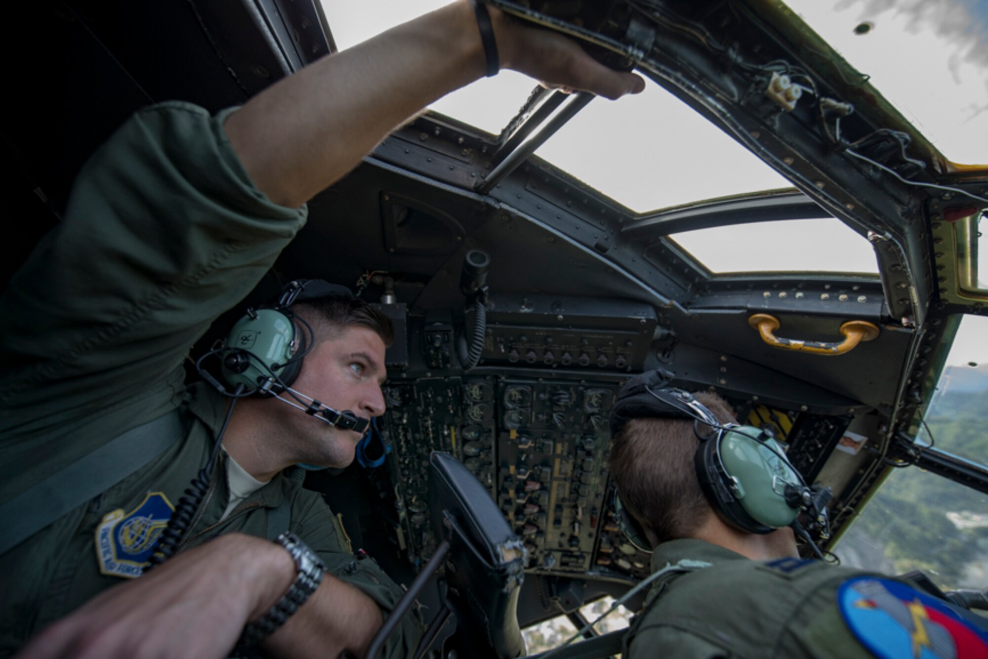 Capt. Andrew Kochman, 36th Airlift Squadron navigator, keeps a lookout while behind a co-pilot during a tactical training mission over Yamanashi Prefecture, Japan, Oct. 5, 2017. This is the last active duty C-130H Hercules tactical training sortie.
