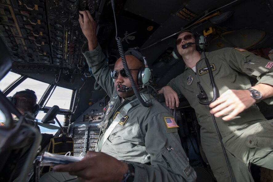 Tech. Sgt. Joshua Pittman, left, 36th Airlift Squadron C-130H flight engineer, inputs a data during a tactical training sortie over Izu Peninsula, Japan, Oct. 5, 2017.