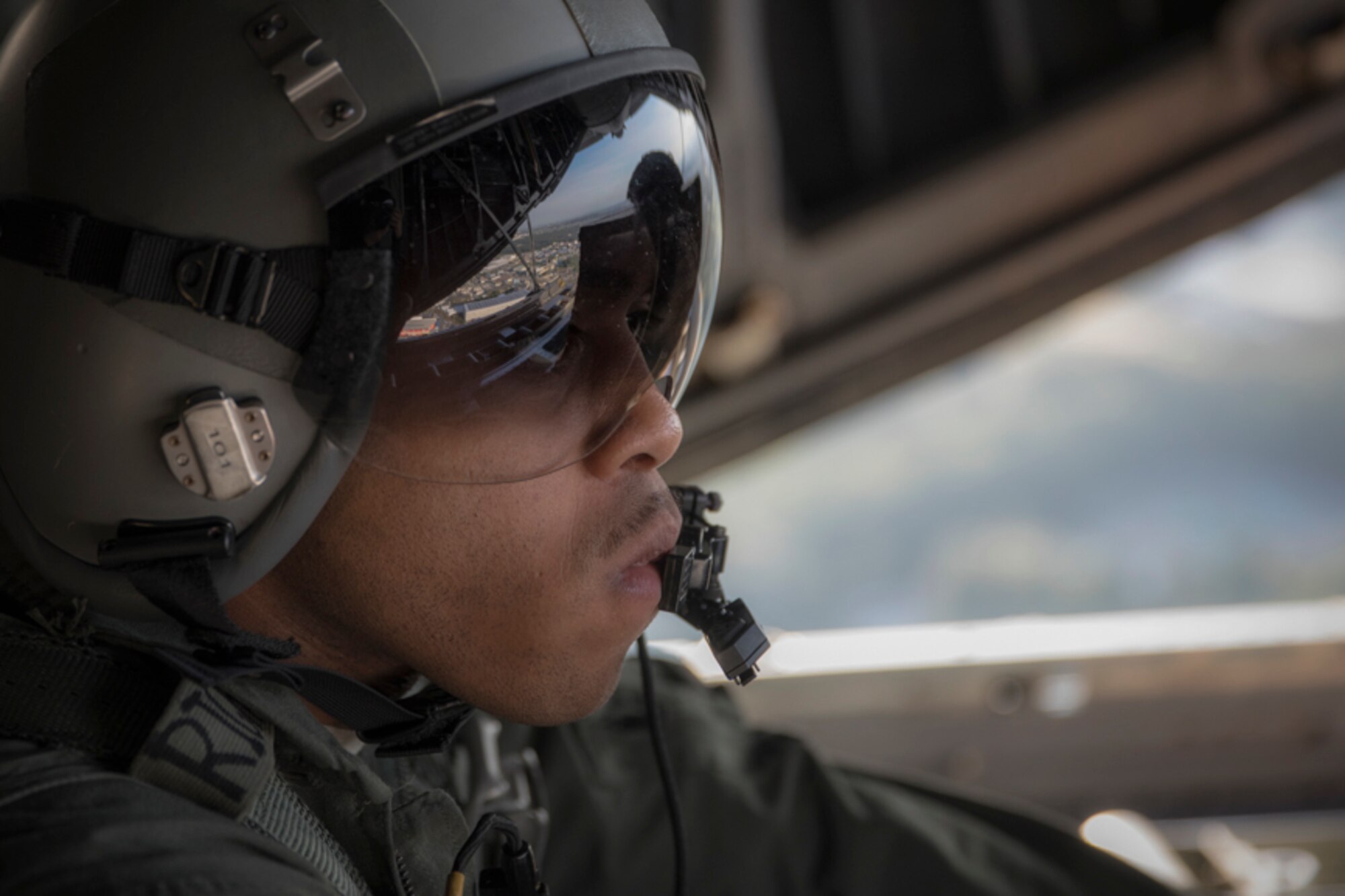 Senior Airman Gary Coe, 36th Airlift Squadron C-130H loadmaster, observes a low-cost, low-altitude bundle drop from a C-130H Hercules over Yokota Air Base, Japan, Oct. 5, 2017. This is the last time active duty C-130H Hercules' crew members perform an LCLA airdrop.