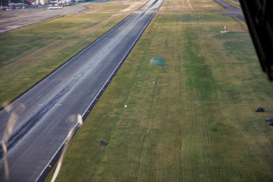 A low-cost, low-altitude bundle falls to the drop zone at Yokota Air Base, Japan, Oct. 5, 2017. This is the last time active duty C-130H Hercules' crew members perform an LCLA airdrop.