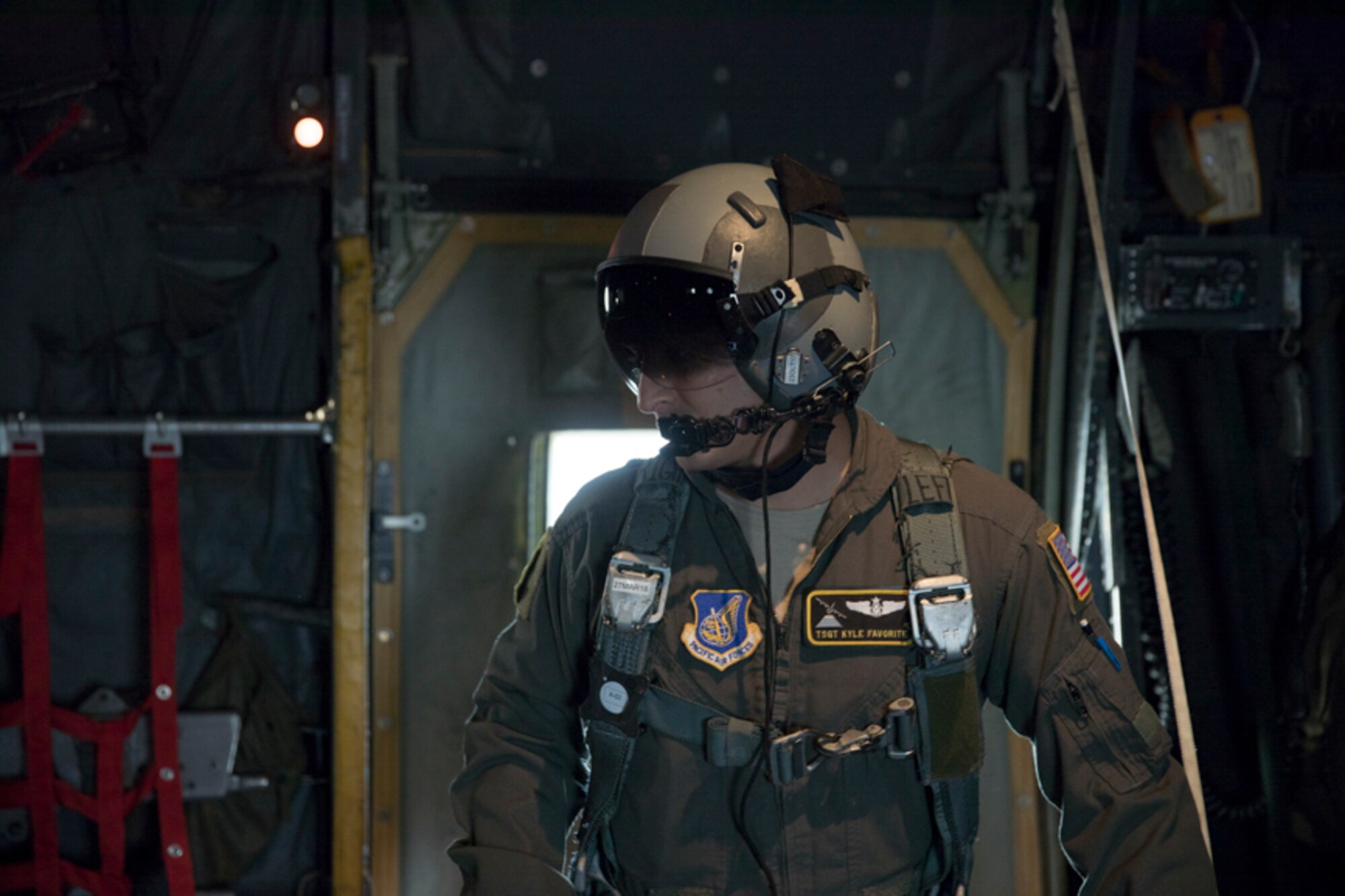 Tech. Sgt. Kyle Favorite, 36th Airlift Squadron C-130H loadmaster, communicates with crew members on a C-130H Hercules after executing a low-cost, low-altitude airdrop training over Yokota Air Base, Japan, Oct. 5, 2017. This is the last time active duty C-130H Hercules' crew members perform an LCLA airdrop.