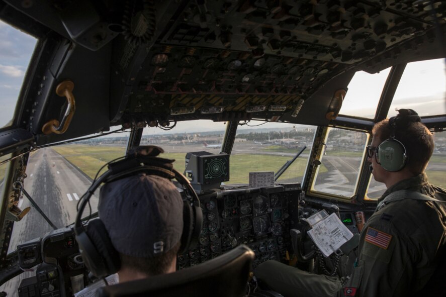 Lt. Col. John Kerr, left, and Capt. Thomas Bernard, 36th Airlift Squadron C-130H pilots, fly over Yokota Air Base, Japan, during a tactical training sortie, Oct. 5, 2017. This is the last active duty C-130H Hercules tactical training sortie.