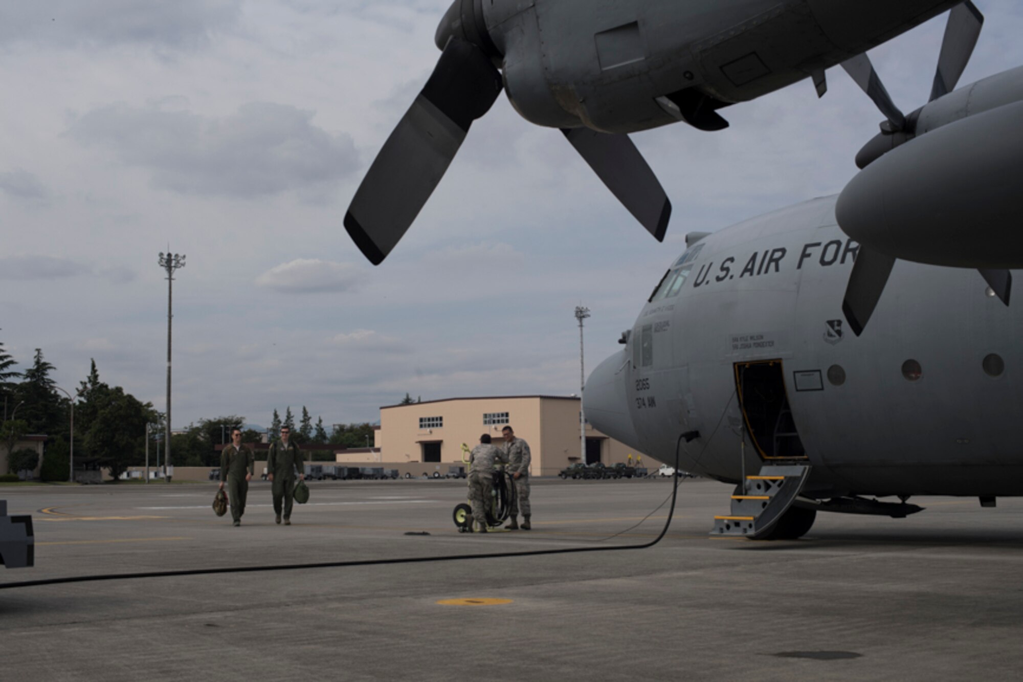 Crew members from the 36th Airlift Squadron walk on the flightline, at Yokota Air Base, Japan, Oct. 5, 2017. This is the last active duty C-130H Hercules tactical training sortie.