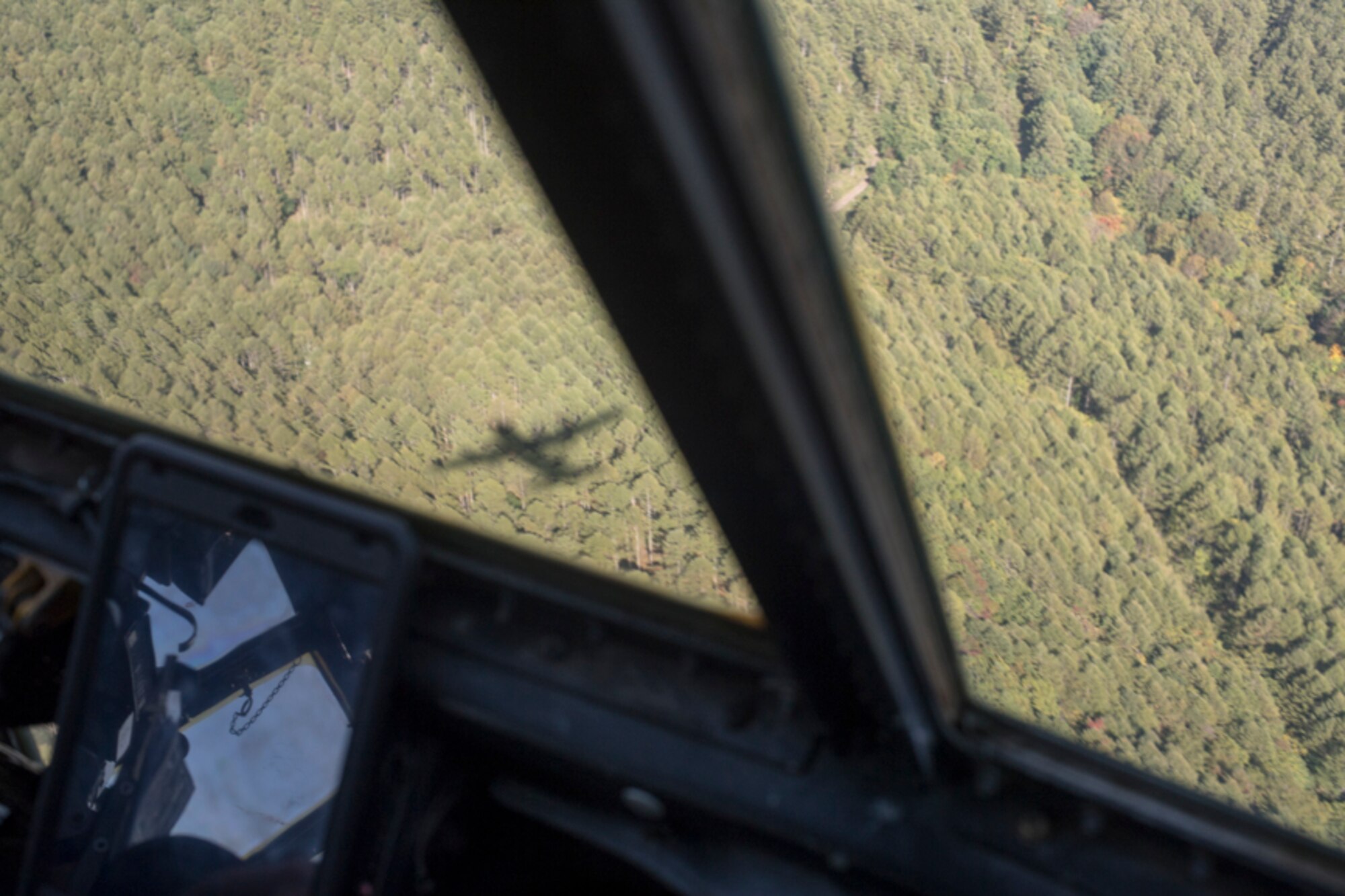 A C-130H Hercules assigned to the 36th Airlift Squadron flies over a forest during a tactical training sortie, over Yamanashi Prefecture, Japan, Oct. 5, 2017. This is the last active duty C-130H Hercules tactical training sortie.