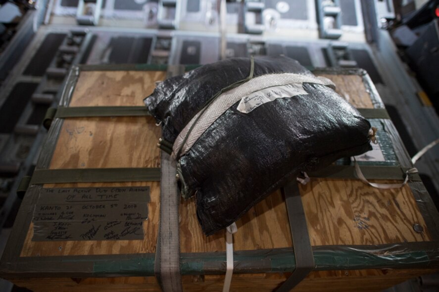 Crew members write messages on a low-cost, low-altitude airdrop bundle on a C-130H Hercules over Yokota Air Base, Japan, Oct. 5, 2017. The message said, "The last active-duty C-130H airdrop of all time. Kanto 21."