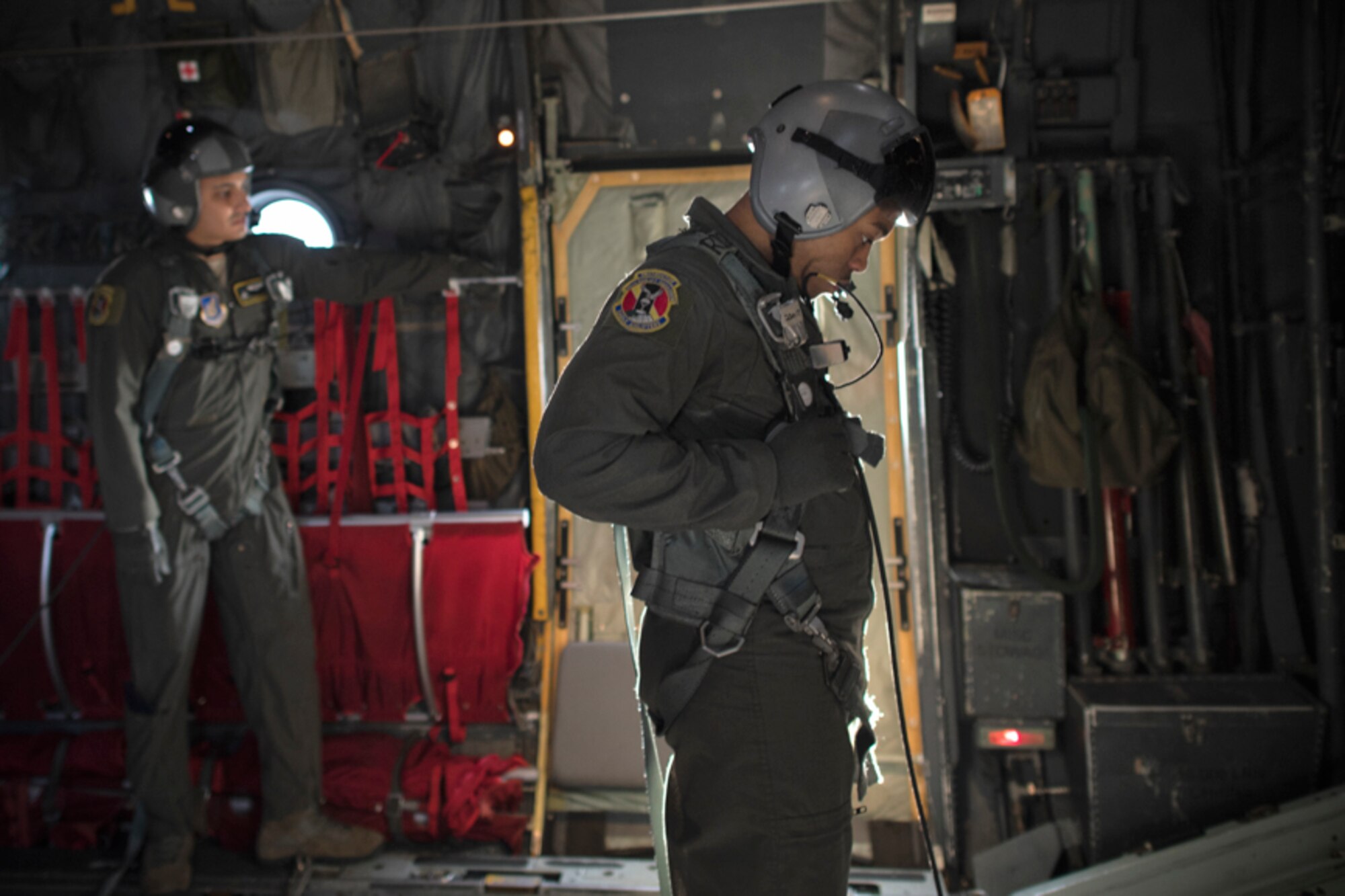 Senior Airman Gary Coe, 36th Airlift Squadron C-130H loadmaster, communicates with crew members before opening the rear ramp of a C-130H Hercules aircraft over Yokota Air Base, Japan, Oct. 5, 2017. This is the last time active duty C-130H Hercules' crew members performed a low-cost, low-altitude airdrop.