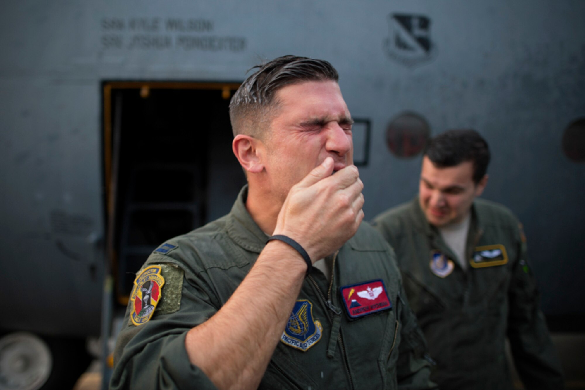 Capt. Andrew Kochman, 36th Airlift Squadron navigator, wipes his face after getting sprayed with water after completing the last active-duty C-130H tactical training sortie at Yokota Air Base, Japan, Oct. 5, 2017.