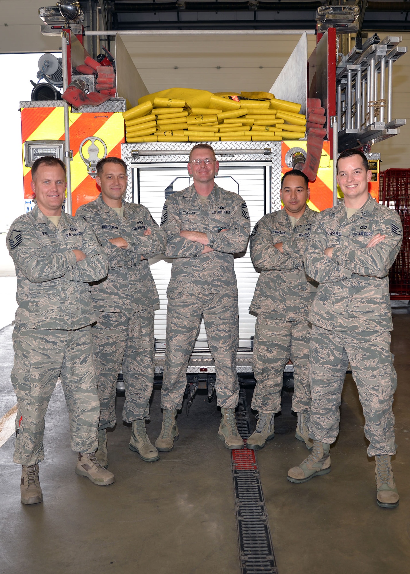 U.S. Air Force Chief Master Sgt. William Taylor, center, 100th Civil Engineer Squadron Fire Department installation fire chief, poses for a photo with some of his firefighter family Sept. 26, 2017, on RAF Mildenhall, England. Taylor was trapped, alone and almost lost his life in a fire during a training session when he was a new Airman in July 1997, aged just 20. Afterwards, he vowed to become a fire chief and that safety, training and family oriented culture would be his main focal points to ensure his team’s success. (U.S. Air Force photo by Karen Abeyasekere)