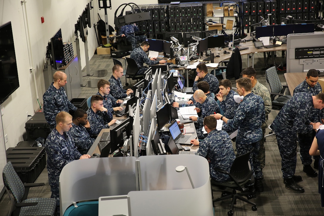 Sailors work together at a joint cyber training center during an April 2017 exercise.