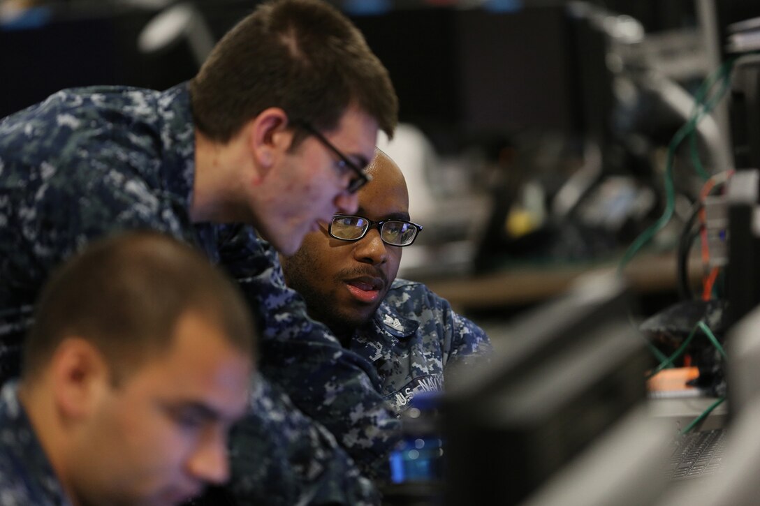 Sailors work together at a joint cyber training center during an April 2017 exercise.