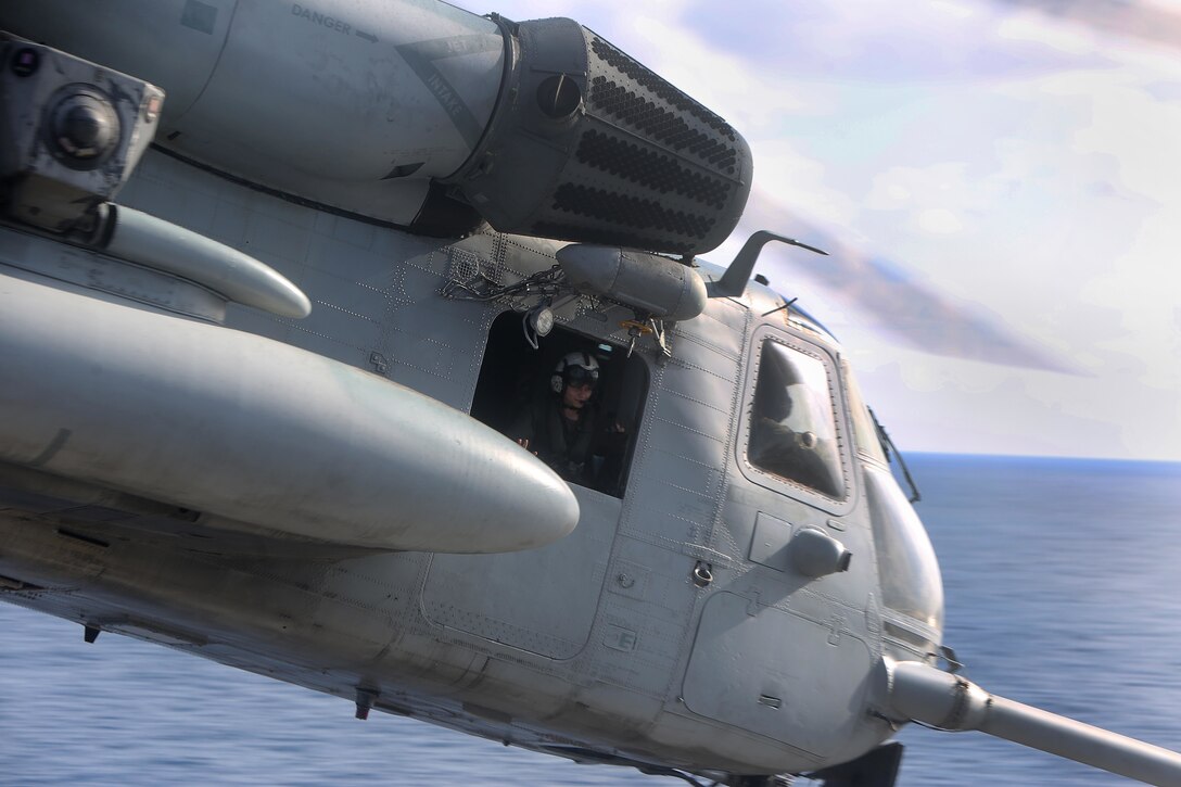 U.S. Marine Corps Cpl. Sarah Green , a crew chief with Marine Medium Tiltrotor Squadron (VMM) 162 (Reinforced), 26th Marine Expeditionary Unit (MEU), observes the amphibious assault ship USS Kearsarge (LHD 3) from a CH-53E Super Stallion helicopter also with VMM 162 (REIN), in the Caribbean Sea, Oct. 12, 2017. The 26th MEU is supporting Federal Emergency Management Agency, the lead federal agency, in helping those affected by Hurricane Maria to minimize suffering and is one component of the overall whole-of-government response effort. (U.S. Marine Corps photo by Cpl. Juan A. Soto-Delgado)