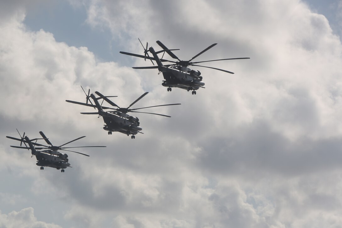 U.S. Marine Corps CH-53E Super Stallion helicopters with Marine Medium Tiltrotor Squadron (VMM) 162 (Reinforced), 26th Marine Expeditionary Unit (MEU), fly in formation above the amphibious assault ship USS Kearsarge (LHD 3) in the Caribbean Sea, Oct. 12, 2017.