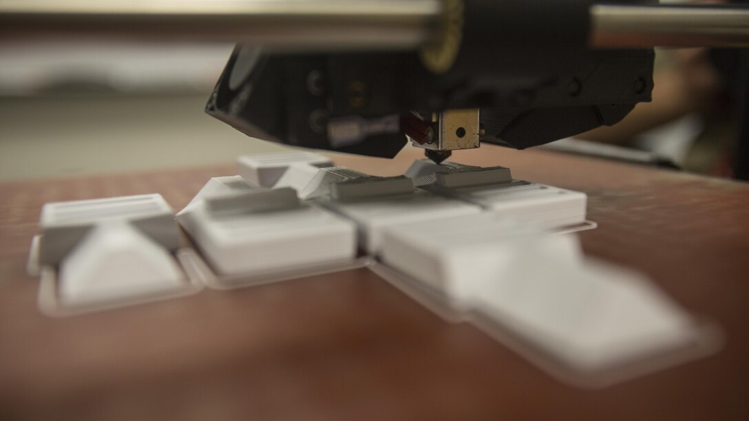 The 3-D printer from 2nd Battalion, 8th Marine Regiment prints pack clips at Camp Lejeune, N.C., Oct. 6, 2017. 2/8 is the first infantry battalion in the United States Marine Corps to utilize a 3-D printer to ensure battalion readiness in the event of equipment malfunctions. (U.S. Marine Corps photo by Lance Cpl. Ashley McLaughlin)