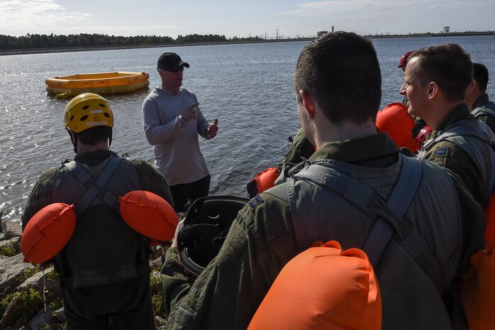 Tech. Sgt. Alan Morse, 437th OSS survival, evasion, resistance and escape NCO in charge, instructs students about water survival training as part of SERE block training prior to the students getting into the water Oct. 2, 2017.