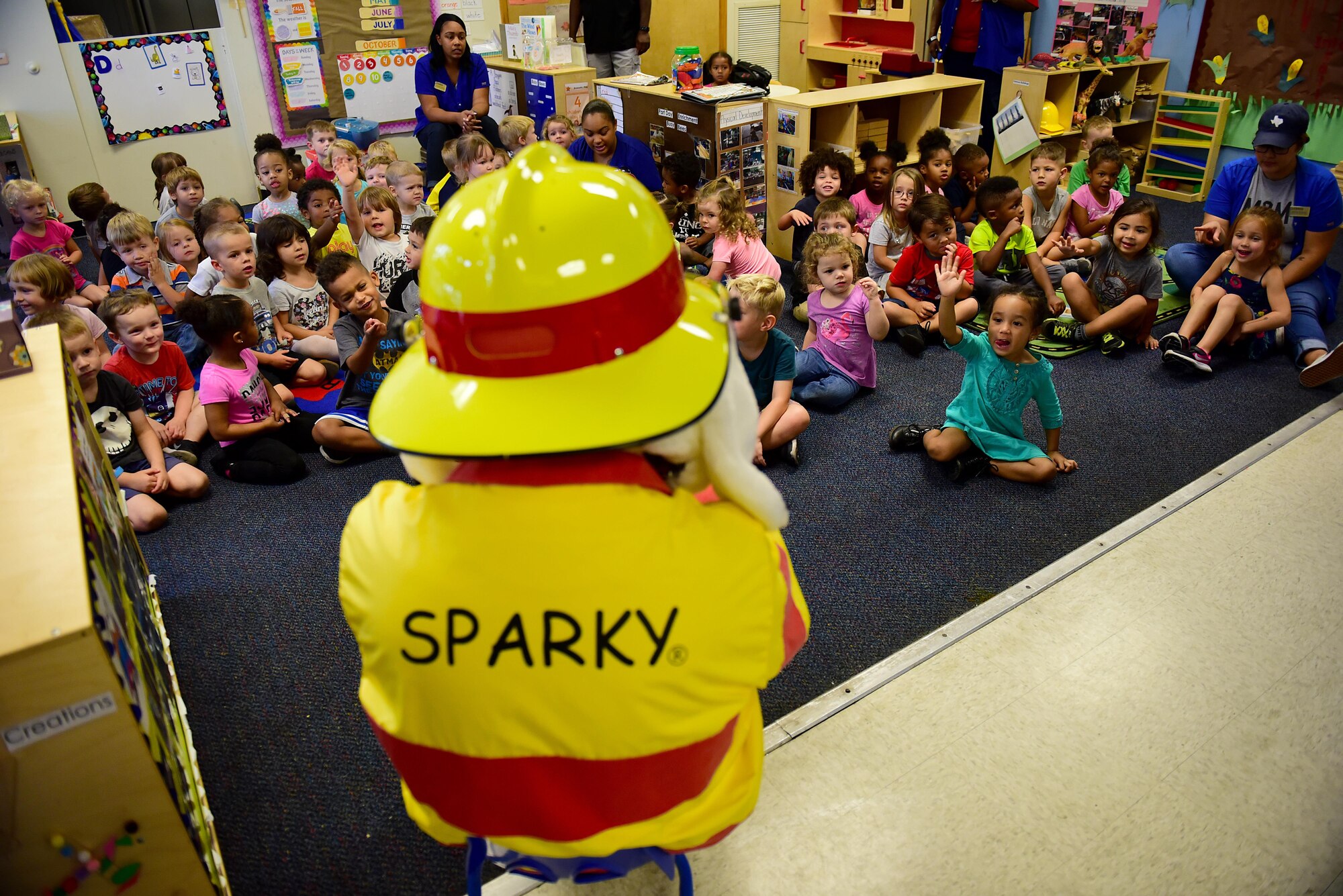 Sparky the Fire Dog sits with a class from the Seymour Johnson Air Force Base 4th Force Support Squadron Child Development Center during a fire safety lesson for Fire Prevention Week, Oct. 12, 2017, at Seymour Johnson AFB, North Carolina. This year’s fire prevention theme is, “Every Second Counts: Plan 2 Ways Out!” (U.S. Air Force photo by Airman 1st Class Kenneth Boyton)