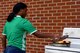 Dellnique Ballen puts out a grease fire during a demonstration at the Base Exchange parking lot for Fire Prevention Week, Oct. 13, 2017, at Seymour Johnson Air Force Base, North Carolina. According to the National Fire Protection Association, almost half of all reported home structure fires are caused by cooking. (U.S. Air Force photo by Airman 1st Class Kenneth Boyton)
