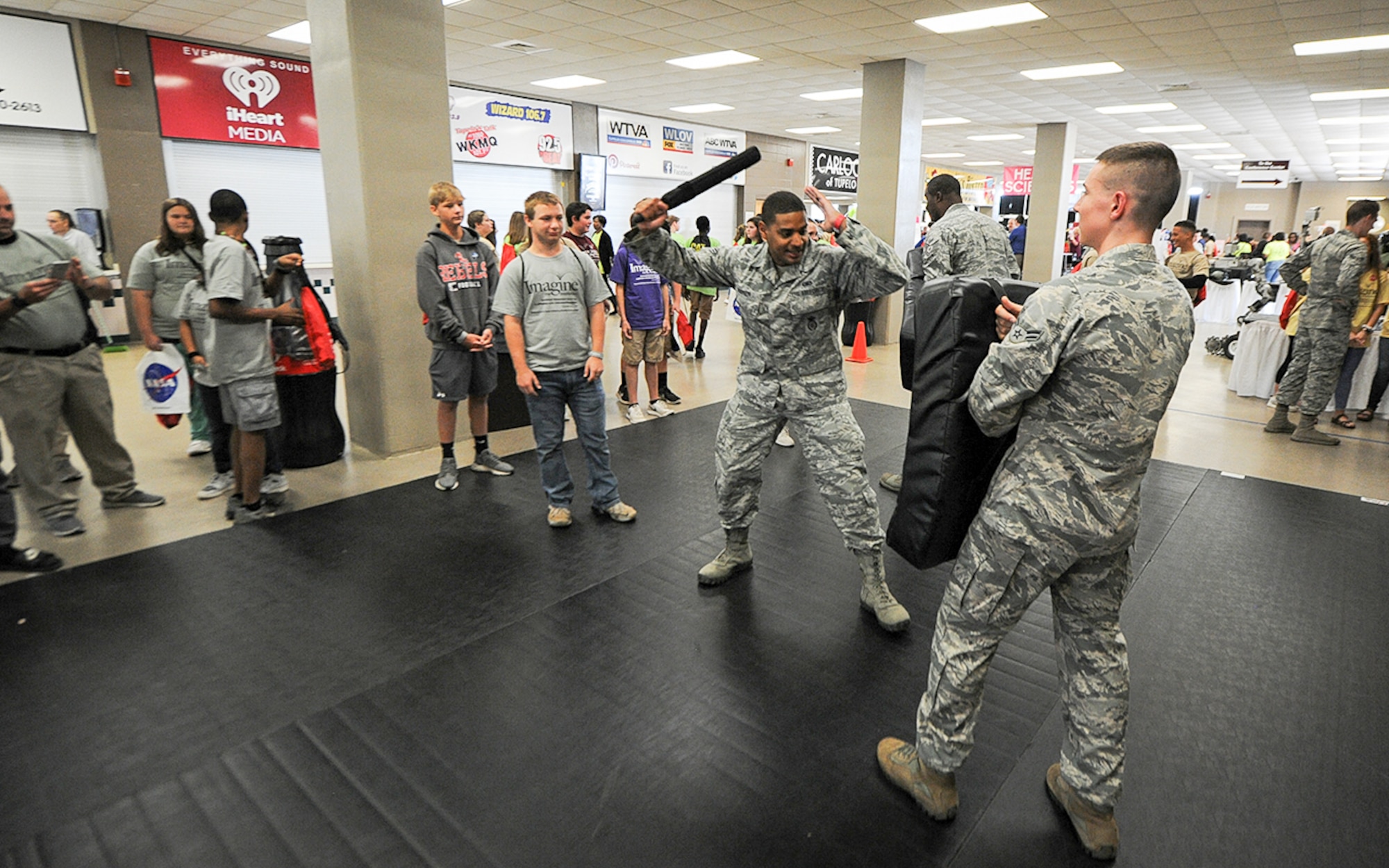 Senior Airman Jasson Adamson, 14th Security Forces Squadron unit trainer, shows a student how to use a baton while protecting themselves and what instructions should be given to have an individual comply Oct. 3, 2017, during the Imagine the Possibilities Career Expo at the BancorpSouth Arena in Tupelo, Mississippi. Airmen from the 14th SFS also had several weapons on display and had several military working dog demonstrations throughout the three days. (U.S. Air Force photo by Staff Sgt. Christopher Gross)
