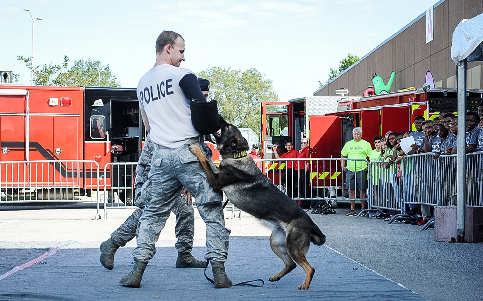 Senior Airman Kyle Jacob, 14th Security Forces Squadron Military Working Dog handler, gets bit while doing a MWD demonstration Oct. 3, 2017, during the Imagine the Possibilities Career Expo at the BancorpSouth Arena in Tupelo, Mississippi. MWD demonstrations were given several times throughout the three–day expo and handlers answered any questions from students and volunteers. (U.S. Air Force photo by Staff Sgt. Christopher Gross)