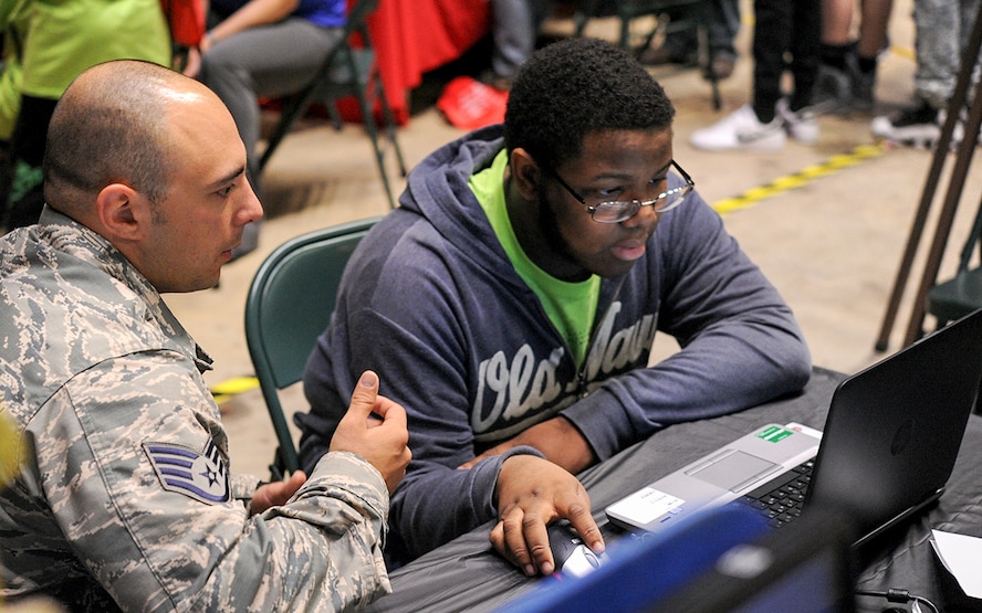 Tech. Sgt. Henry Schultz, 14th Logistics Readiness Squadron NCO in Charge of Logistics Plans, helps a student use ICODES software on a computer Oct. 3, 2017, during the Imagine the Possibilities Career Expo at the BancorpSouth Arena in Tupelo, Mississippi. The software is used to help find the center of balance on an aircraft. (U.S. Air Force photo by Staff Sgt. Christopher Gross)