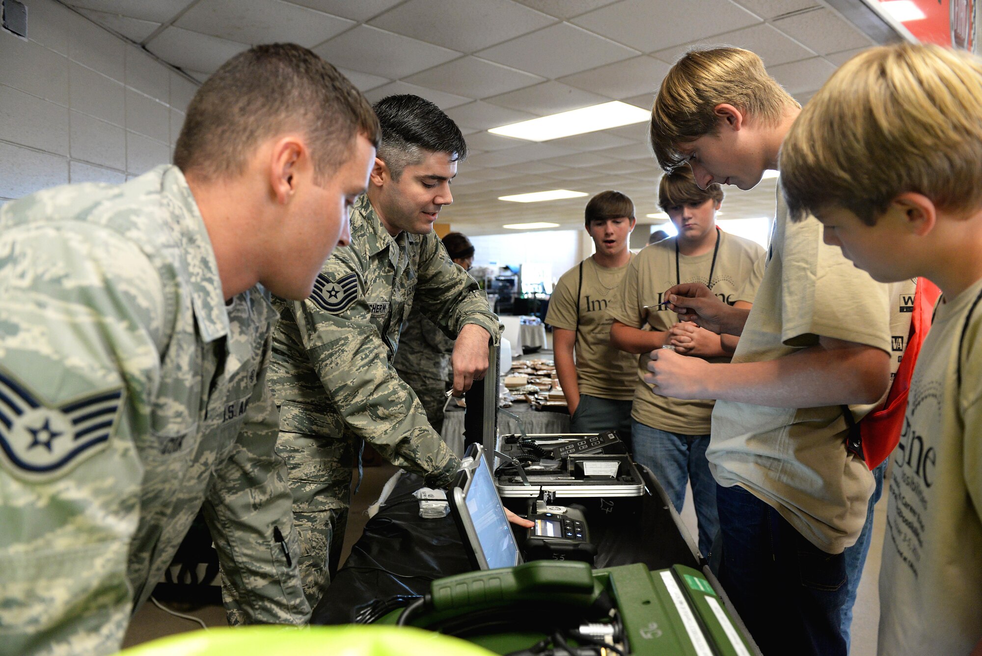 Staff Sgt. Bryce Cook and Tech. Sgt. George MacEachern and, 14th Medical Group bioenvironmental technicians, guide students through some interactive activities Oct. 4, 2017, during the Imagine the Possibilities Career Expo at the BancorpSouth Arena in Tupelo, Mississippi. Bioenvironmental engineering specialists focus on reducing health hazards in the workplace and the surrounding areas, keeping Airmen and their communities safe. (U.S. Air Force photo by Airman 1st Class Keith Holcomb)