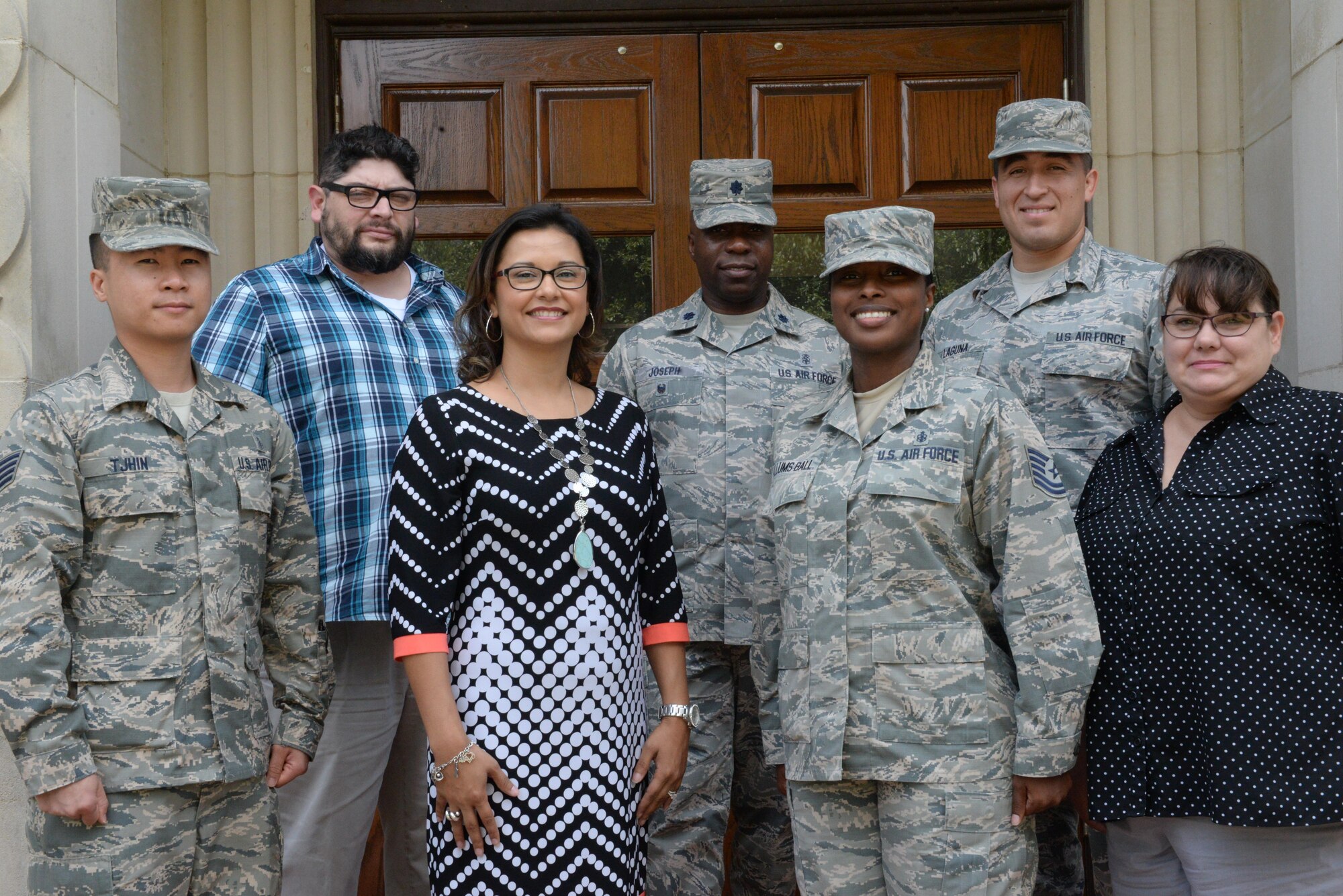 Lt. Col. Christopher Joseph, Medical Support Division chief (second row, center) and the team pose for a photo.  On a daily basis, they provide administrative, information systems, logistics and resource management services to the command surgeon general, while supporting 14 medical units located at two medical centers and a joint training platform. (U.S. Air Force photo by 1st Lt. Geneva Croxton)