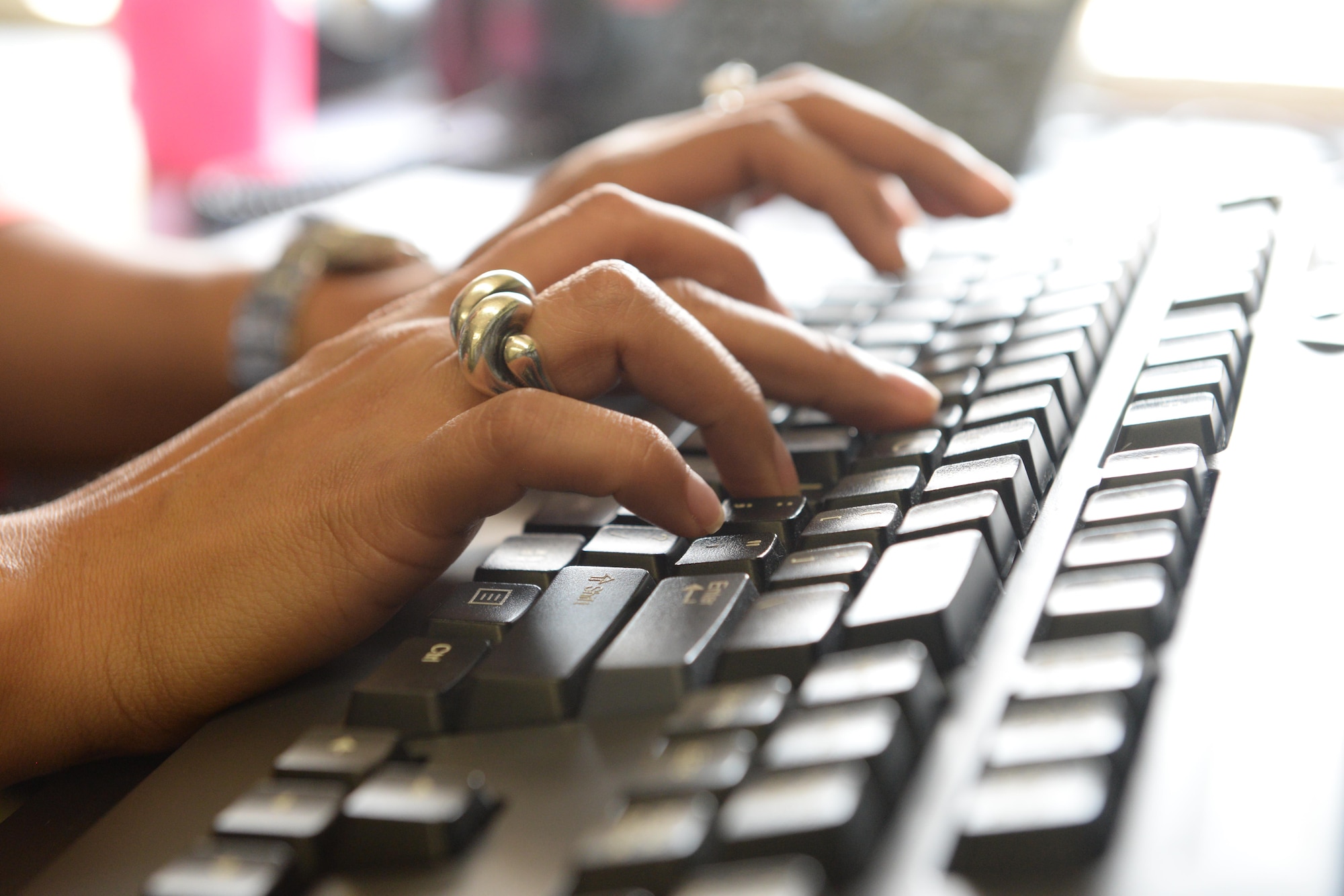 A civilian Airman from the Air Education and Training Command Surgeon General Medical Support Division works at her computer.  A key responsibility of the Medical Support Division is ensuring AETC’s current and planned resourcing requirements are codified and articulated for unfunded or program objective memorandum considerations and resourcing. (U.S. Air Force photo by 1st Lt. Geneva Croxton)