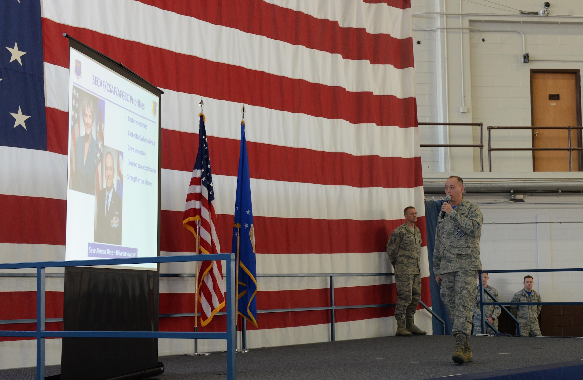 Col. John Edwards, the 28th Bomb Wing commander, emphasizes the five mission priorities from the Air Force and major command level during a wing all-call in the Pride Hangar at Ellsworth Air Force Base, S.D., Oct. 13, 2017. The five priorities are to restore operational readiness, modernize the Air Force in the most cost-effective ways, drive innovation, develop exceptional leaders and strengthen the bonds between the military’s allies. (U.S. Air Force photo by Airman Nicolas Z. Erwin)