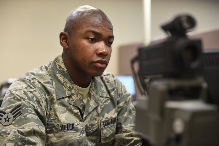 Senior Airman Dennis Allen III, 628th Force Support Squadron Military Personnel Flight customer support technician, prepares to take a new common access card identification photo at the MPF building at Joint Base Charleston, S.C., Oct. 10, 2017.